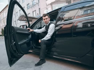 Professional chauffeur providing limo service in Redmond with luxury sedan