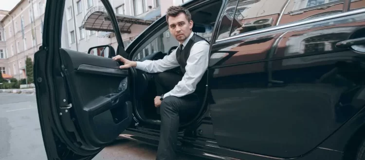 Professional chauffeur providing limo service in Redmond with luxury sedan